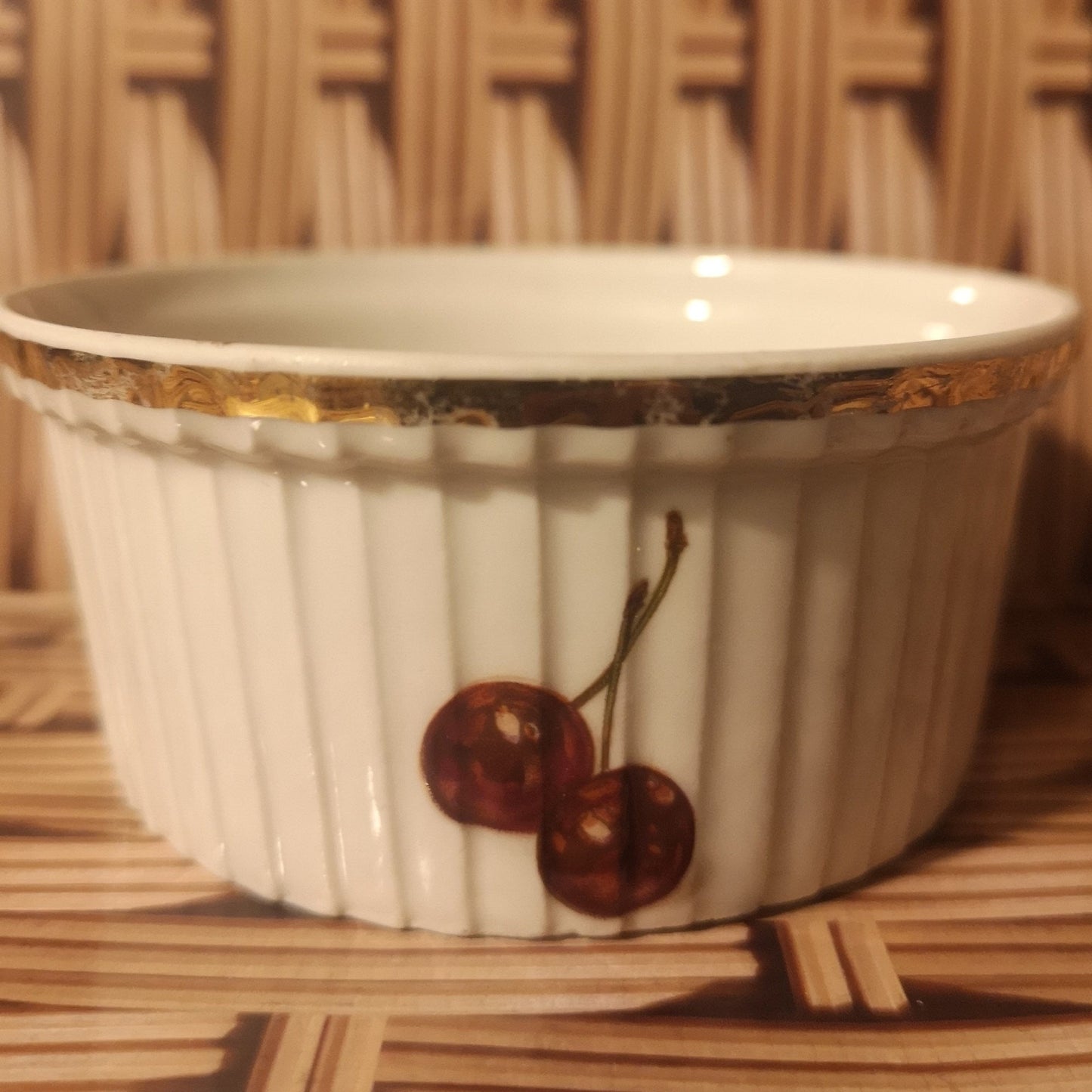 J Chomete & son Pilivite ramekin with gold rim which is worn