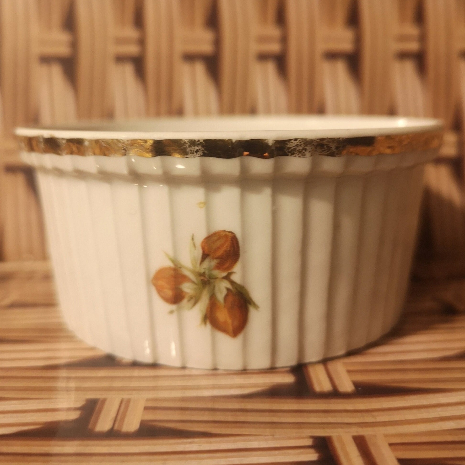 J Chomete & son Pilivite ramekin with gold rim which is worn