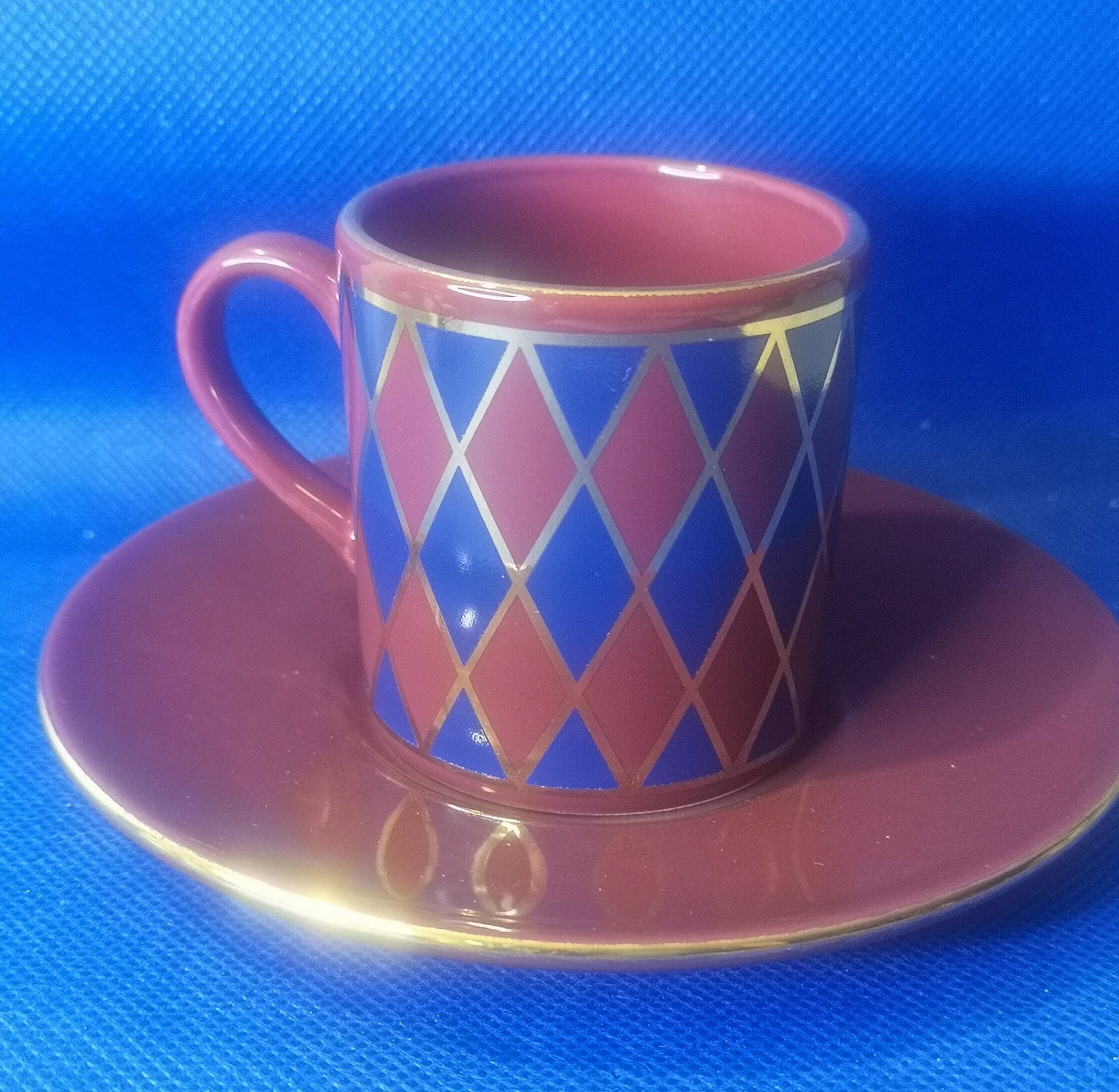 Hornsea pottery burgundy and blue harlequin demitasse cup and saucer