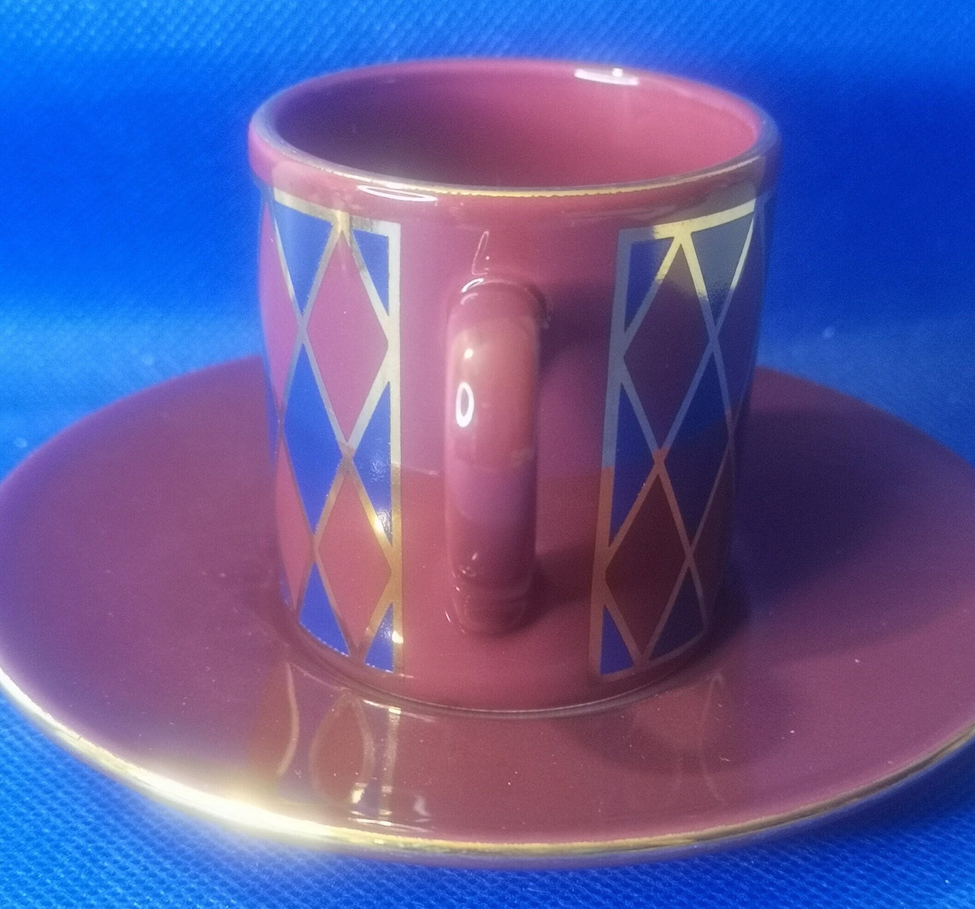 Hornsea pottery burgundy and blue harlequin demitasse cup and saucer